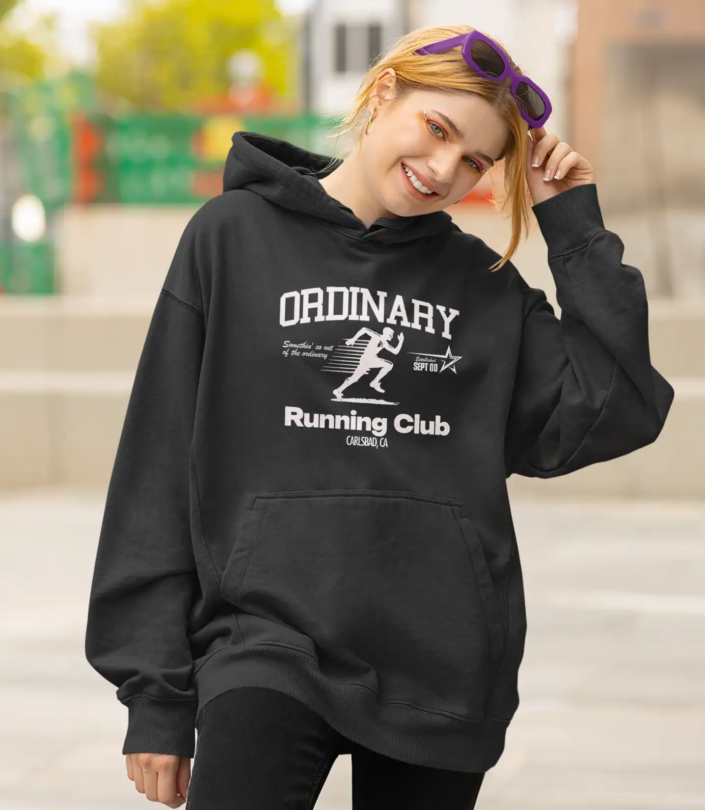 Comfy black hoodie with "Ordinary Running Club" graphic design and kangaroo pocket.