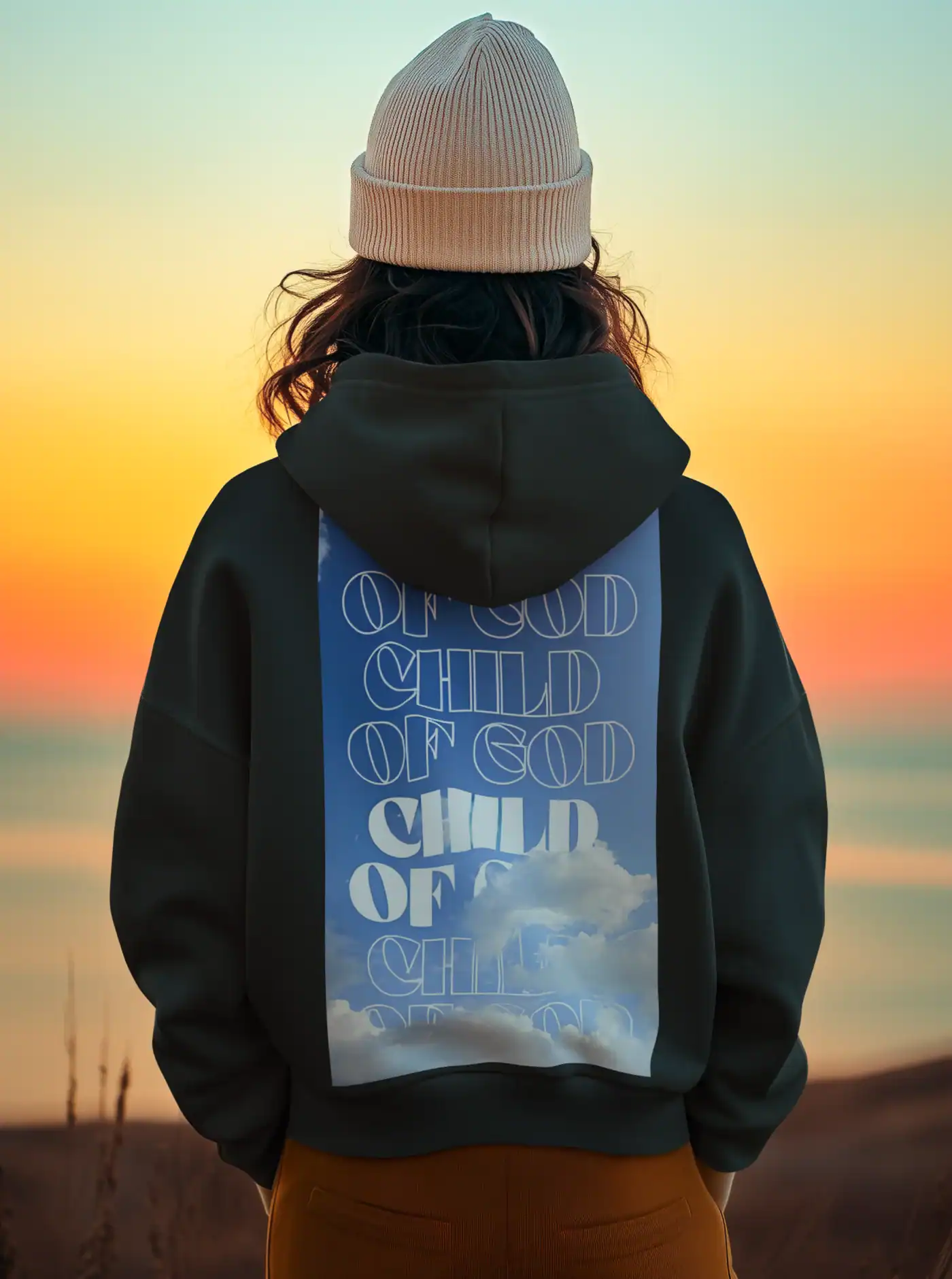 Child of god kpop merch hoodie, black hoodie with cloud and text design, sunset background, fashionable streetwear, popular K-pop fandom merchandise.