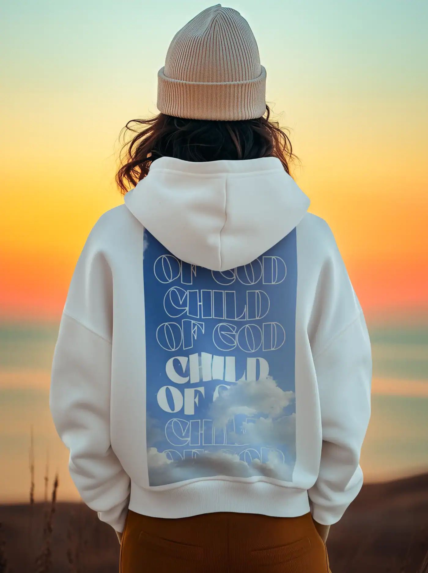Soft white hoodie with cloud graphic and text print, person wearing a beige beanie, sunset background, casual streetwear, K-pop merch styled.