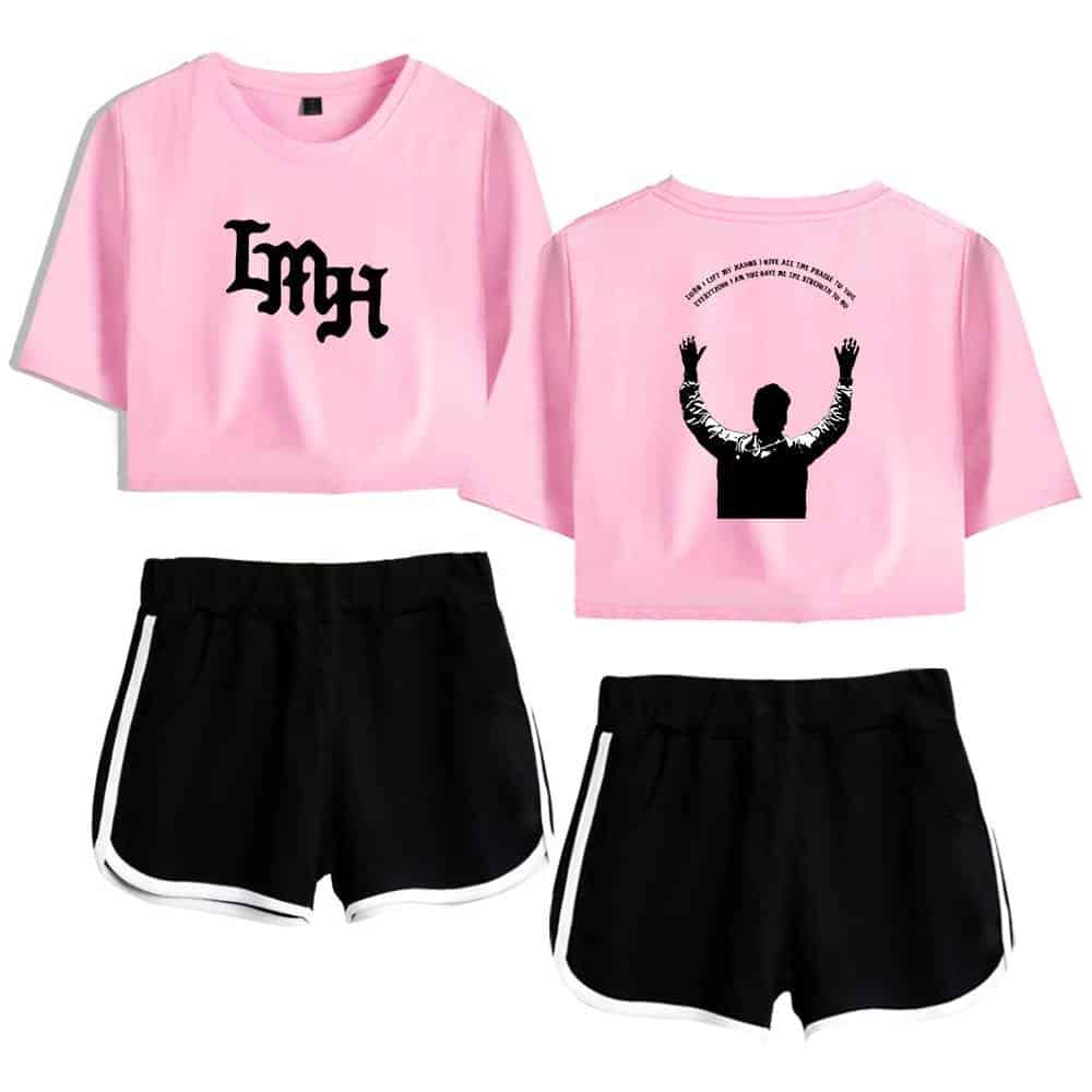 Pink crop top with black graphic design, casual black shorts with white trim, Korean pop star-inspired merchandise, trendy K-pop fashion outfit, stylish K-pop clothing set.