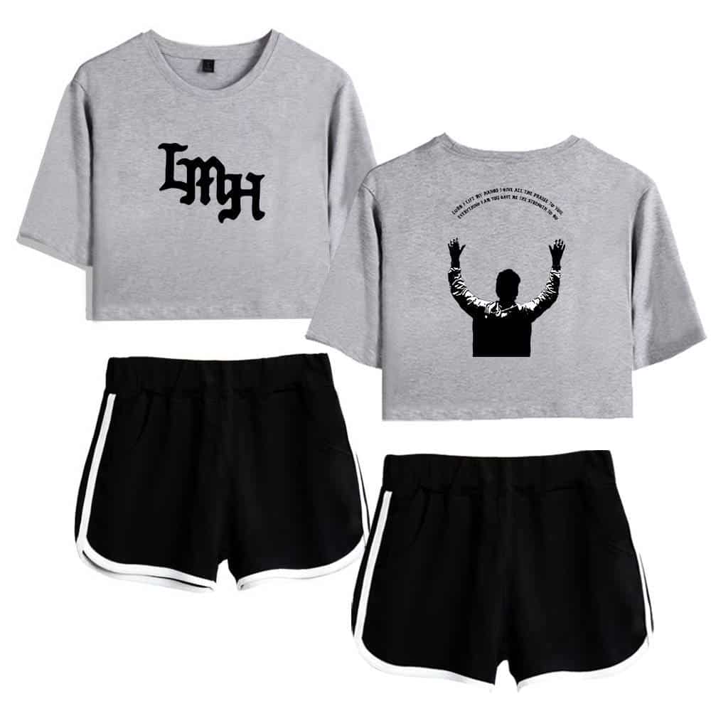 Grey crop top with black text and black shorts with white piping.