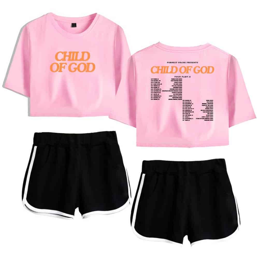 Child of God pink crop top t-shirt with tour schedule back print, casual black athletic shorts with white trim, K-pop merchandise.
