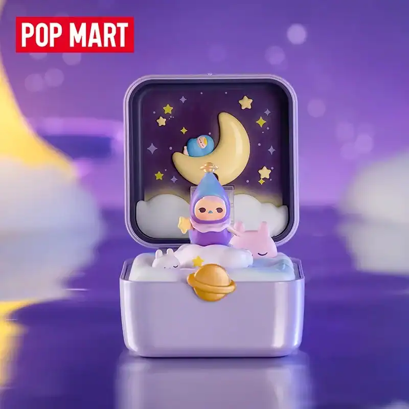 Cute kpop merch figure with space-themed design and pastel colors in a jewelry box setting.