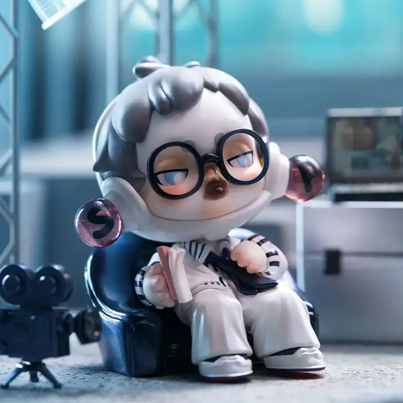 High-quality kpop merchandise collectible figure cat character with glasses sitting on black chair funko style doll for fans of Korean pop music.