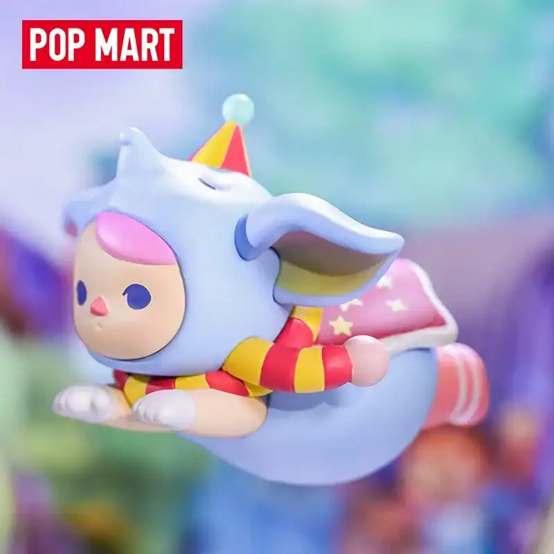 Cute plush toy featuring a cartoon character with a blue unicorn hat, colorful striped scarf, and a playful design. Perfect for K-pop merch collection.