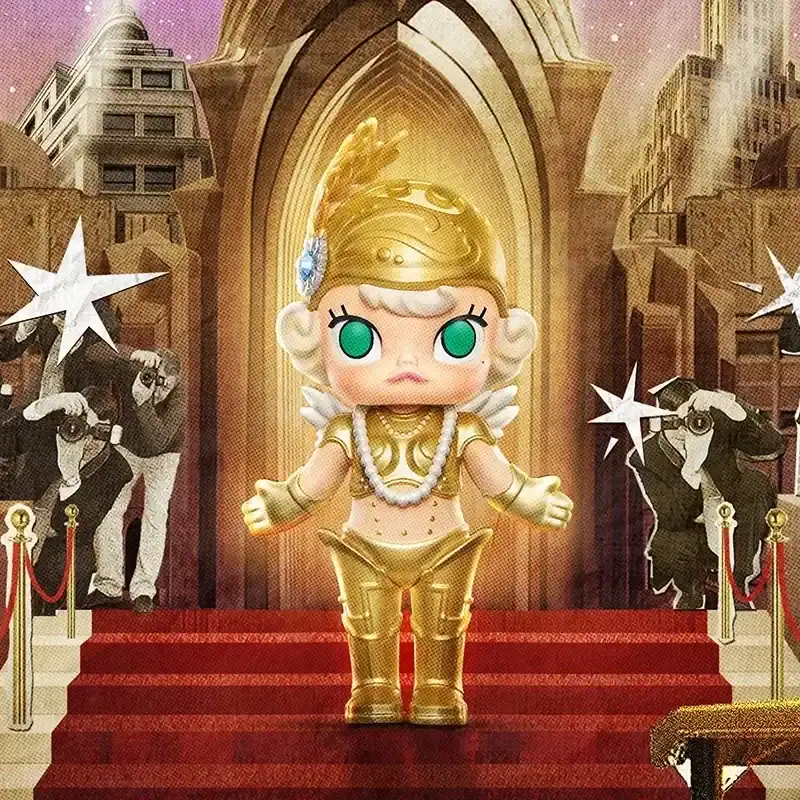 Cute K-pop merch featuring a chibi-style figure dressed as a goddess on a red carpet with a grand architectural backdrop and photographers in the background.