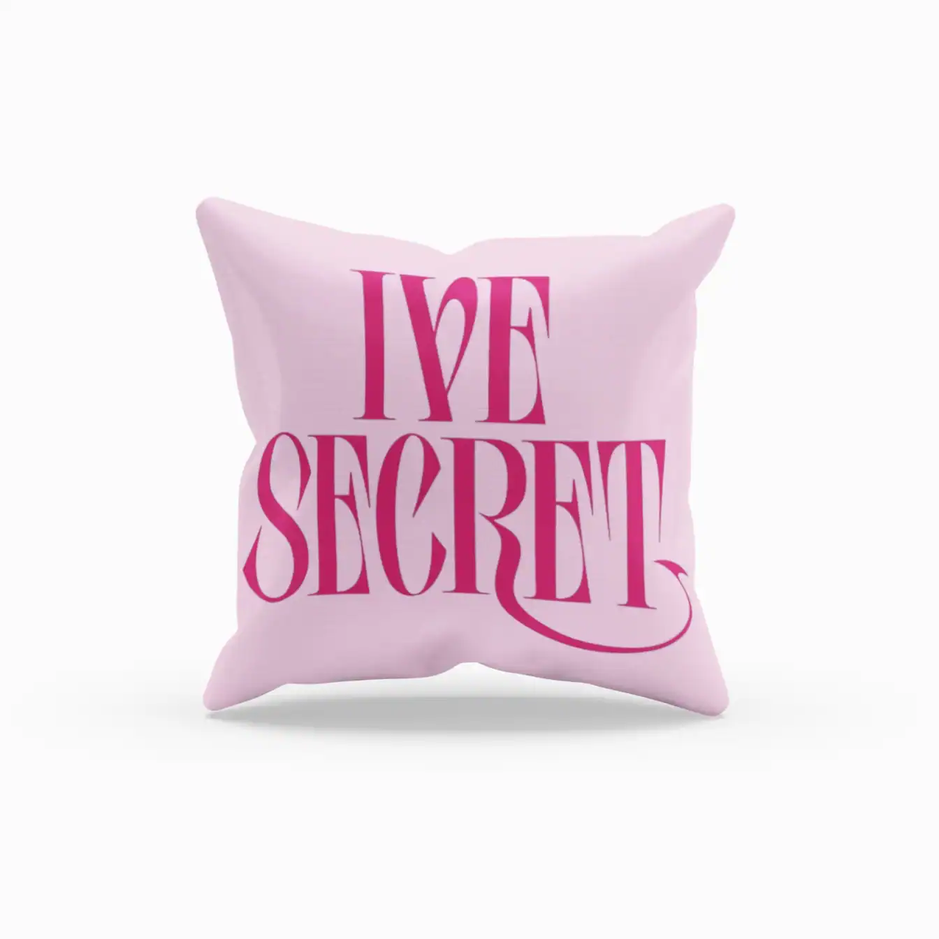 Pink pillow with "I LOVE SECRET" text in bold pink lettering.
