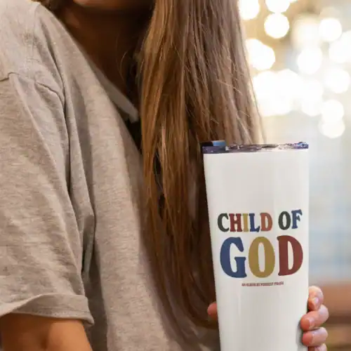 Child of god mug with colorful text and font style.