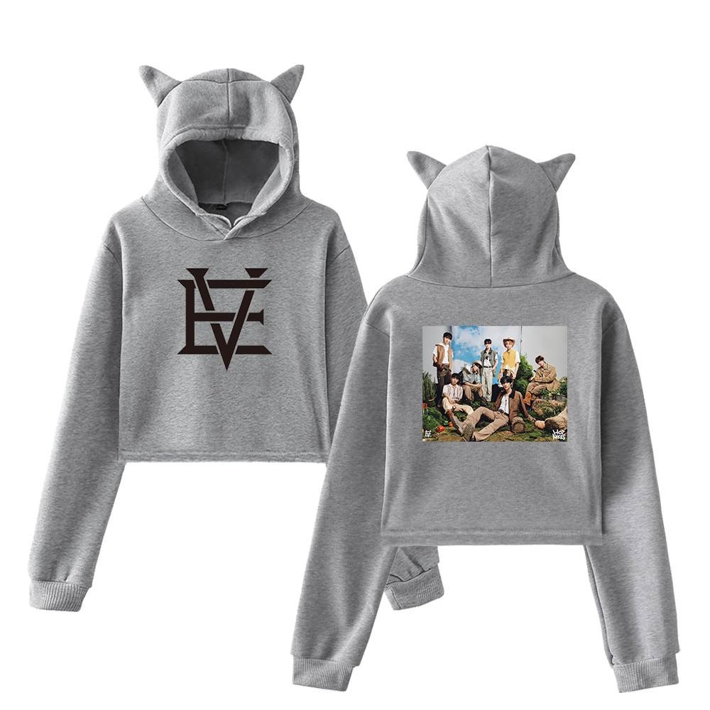 Soft grey hoodie with cat ears and a stylish black logo on the front, featuring a group photo of a K-pop band on the back, perfect for K-pop fans and merch collectors.